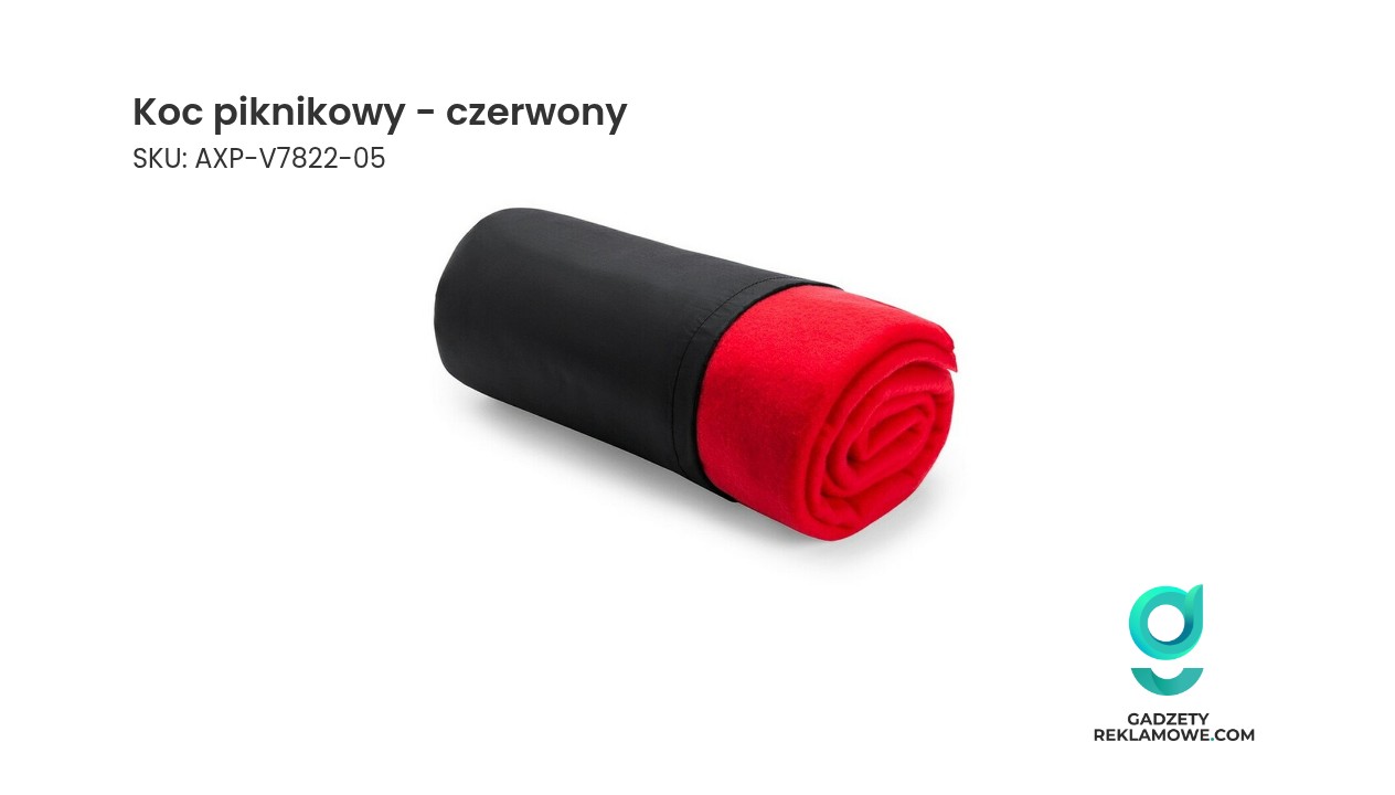 Czerwony koc piknikowy rozłożony na trawie